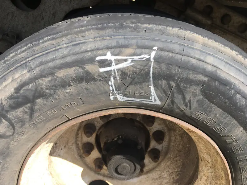 Semi truck tire inspection showing wear requiring immediate service